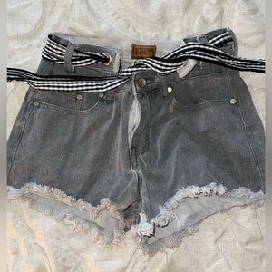 Black/grey high-rise denim shorts with gingham tie/belt.